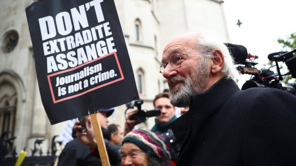 John Shipton, father of Wikileaks founder Julian Assange, walks outside the Royal Courts of Justice in London