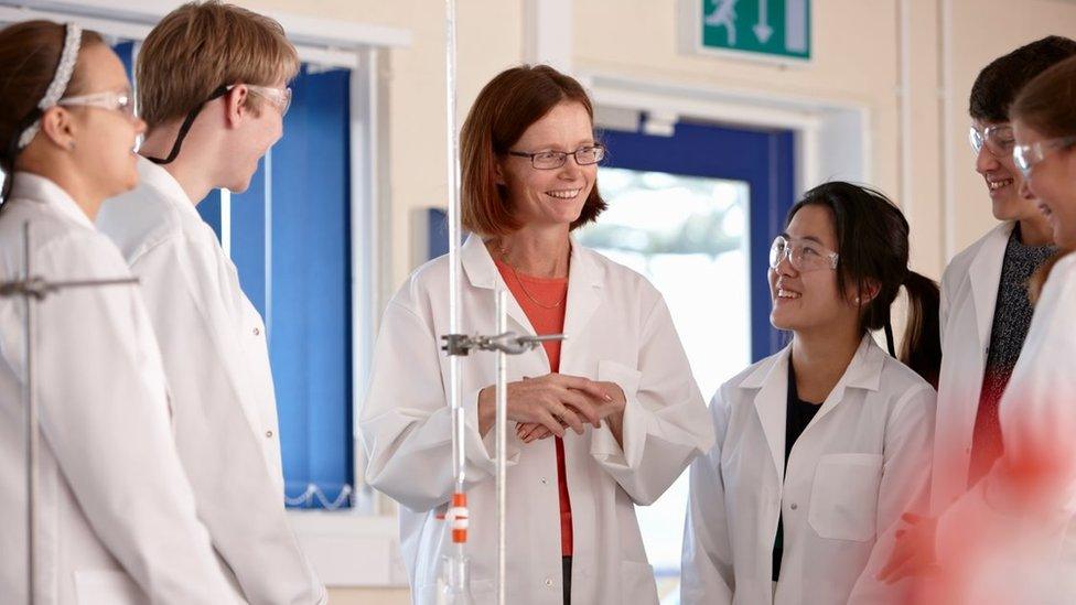 Teacher and pupils in a science lab