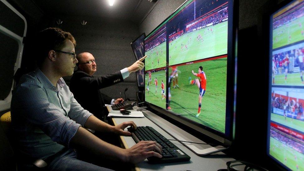 World Rugby official in a Hawk-Eye van with technician