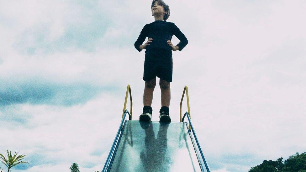 Joao at top of a slide