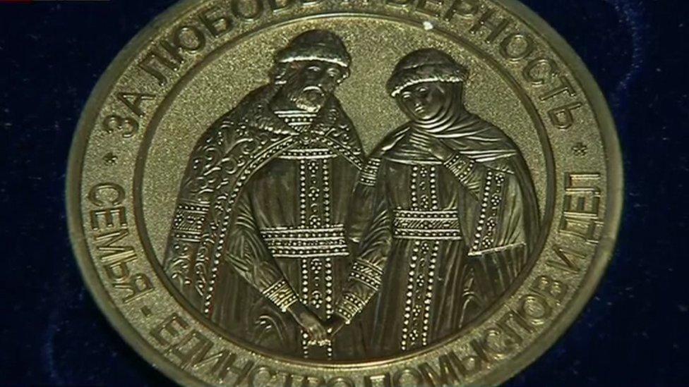 One of the medals being given to couples