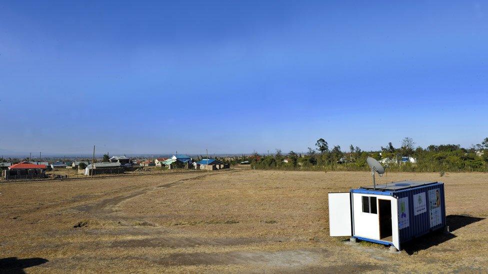 Shipping containers with a satelite dish on top