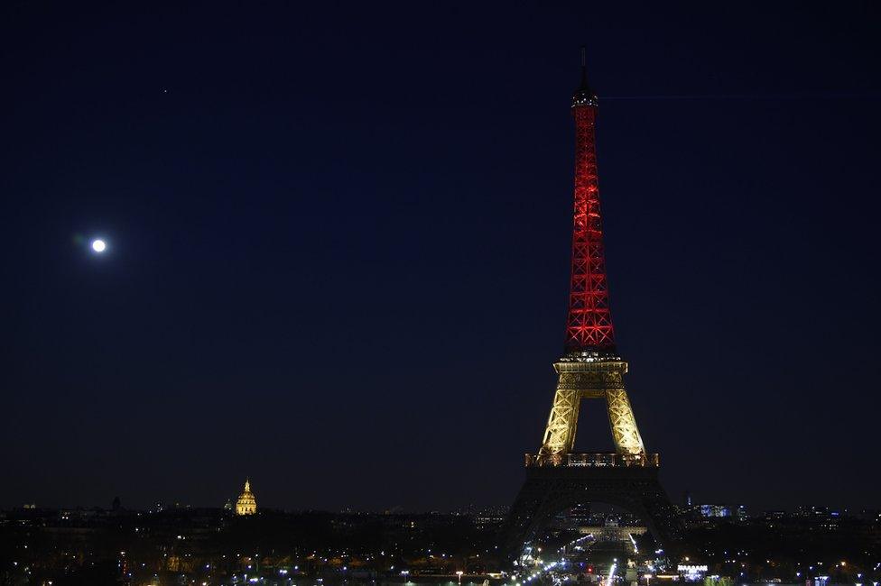 Eiffel Tower in Paris illuminated in colours of the Belgian flag