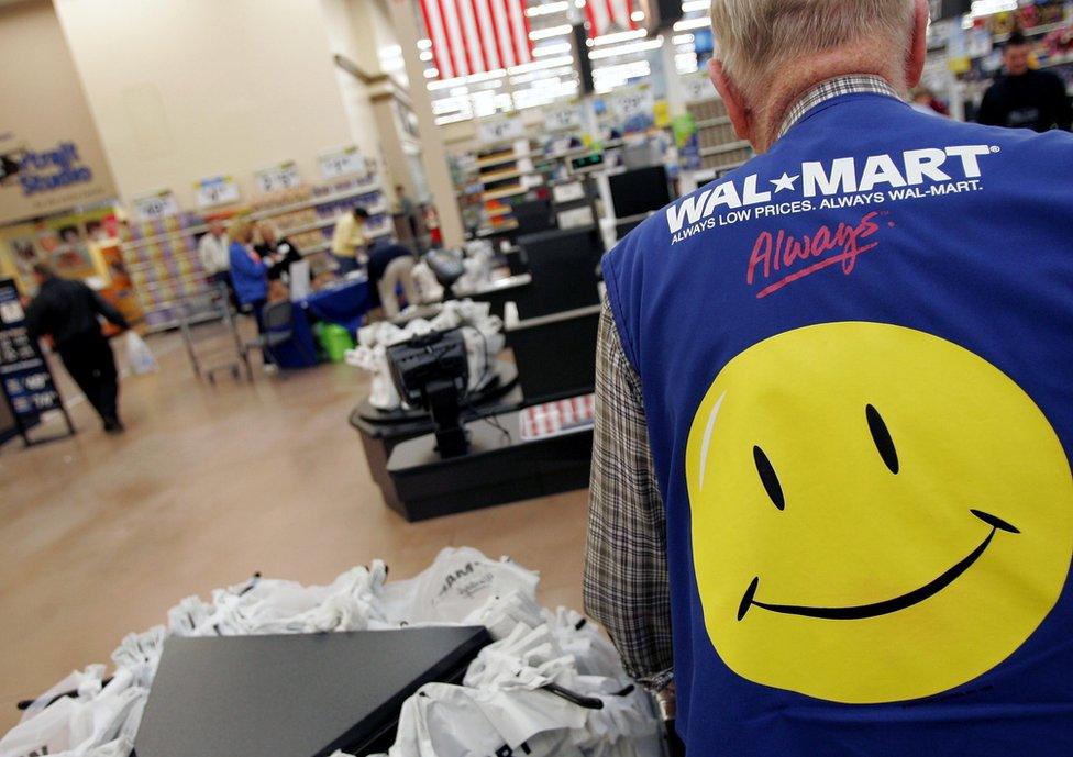 Wal-Mart employee with smiley face vest