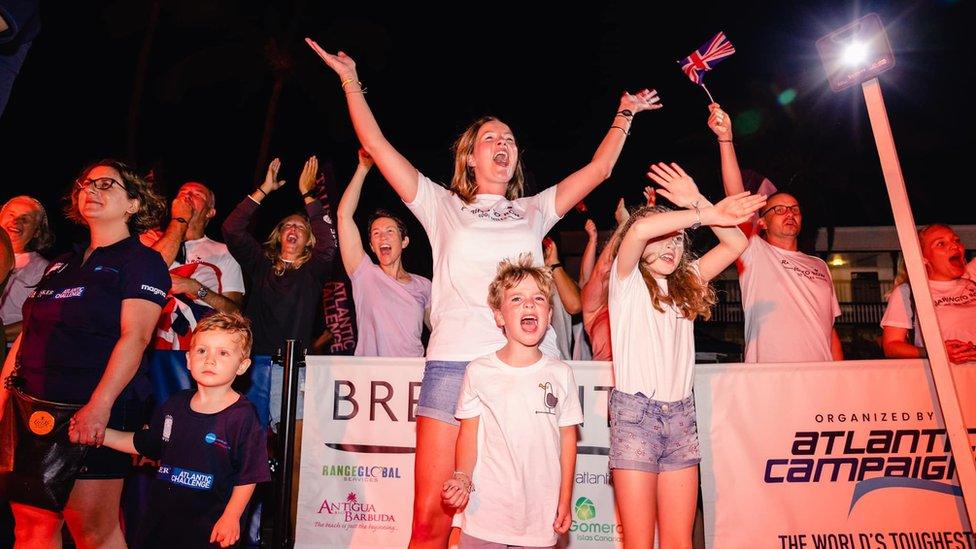 Supporters cheer at the finish line of the Talisker Whisky Atlantic Challenge