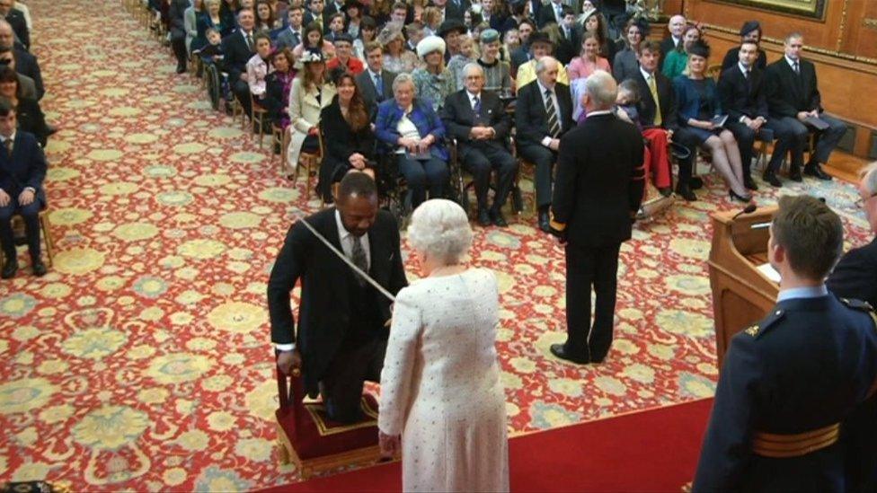 Lenny Henry receives his knighthood from the Queen