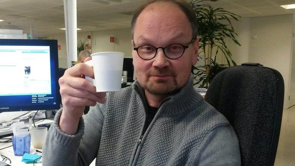 Niilo Simojoki drinking a coffee in his office in Helsinki, Finland