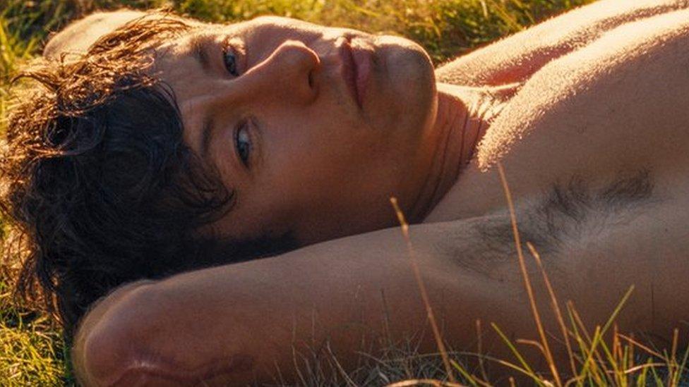 Barry Keoghan lying shirtless in Saltburn