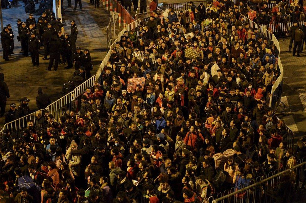 Passengers wait to enter a railway station after trains were delayed due to bad weather in southern China in Guangzhou, Guangdong province, 1 February 2016.