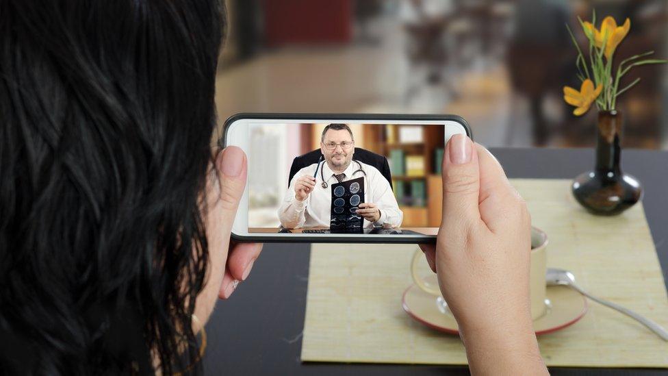 Woman consulting doctor via smartphone video