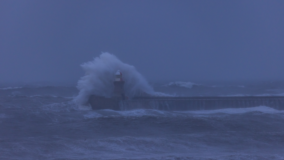 The wave grows in height over South Shields Lighthouse