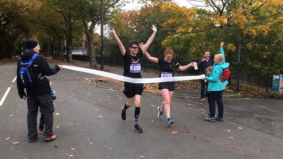 Michael Divers finishing his charity marathon with his girlfriend