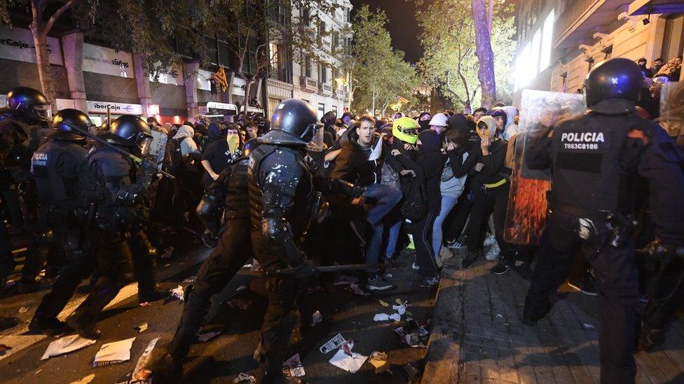 Riot police hold back protesters in Barcelona, Spain on 15 October