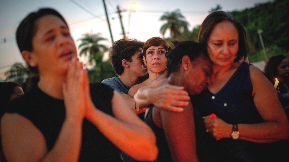 People taking part in a vigil in tribute to the dam disaster dead