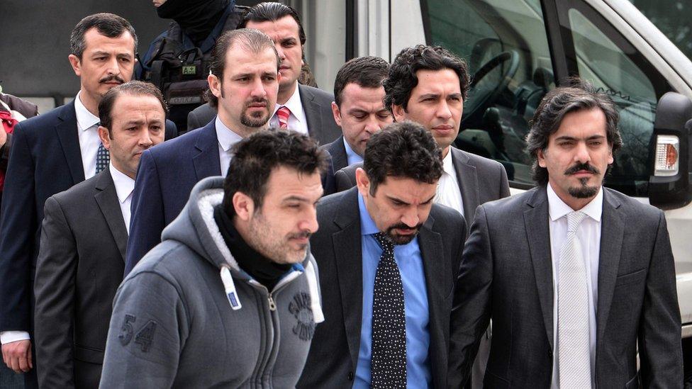 The eight Turkish army officers are escorted by Greek police as they arrive at the Greek Supreme Court on 26 January 2017