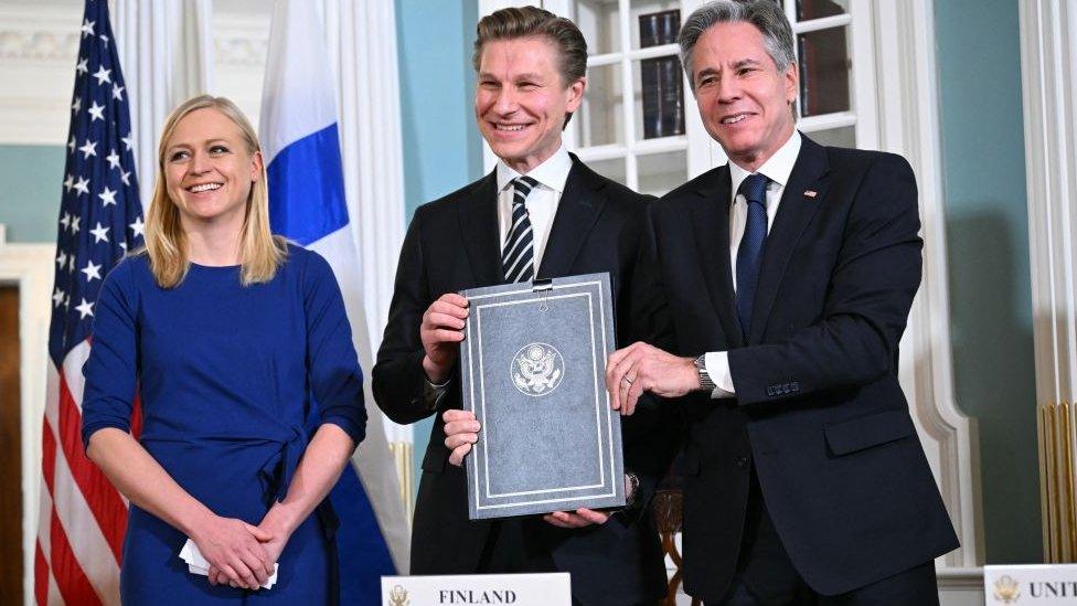 Finnish Foreign Minister Elina Valtonen and Defence Minister Antti Hakkanen with US Secretary of State Antony Blinken pose for a photo after signing an agreement