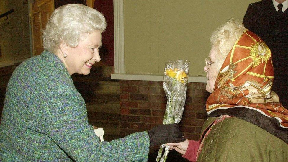 The Queen receiving flowers from Dorothy Cornwell