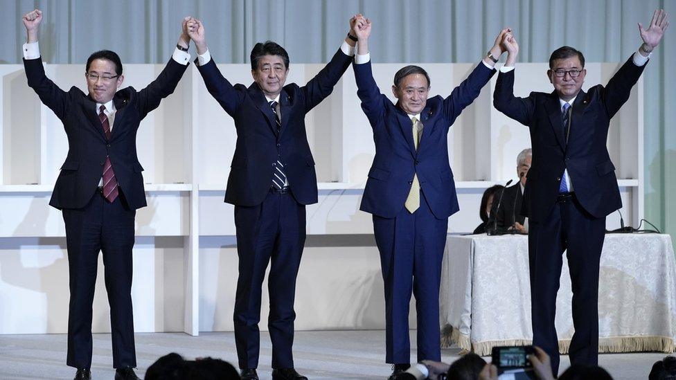 Yoshihide Suga (third from left) celebrates after winning the party leadership