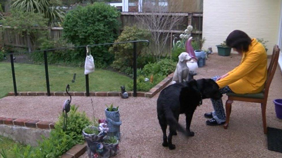 Thelma Evans with her black dog Zebedee