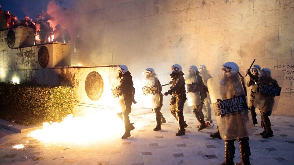 Greek police clash with protesters in front of parliament on May 18, 2017 in Athens