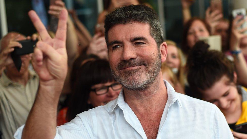 Simon Cowell looking happy