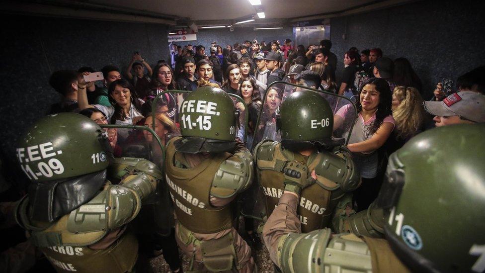 Chilean Police close the access to the Los Heroes metro station in the middle of a demonstration, in Santiago