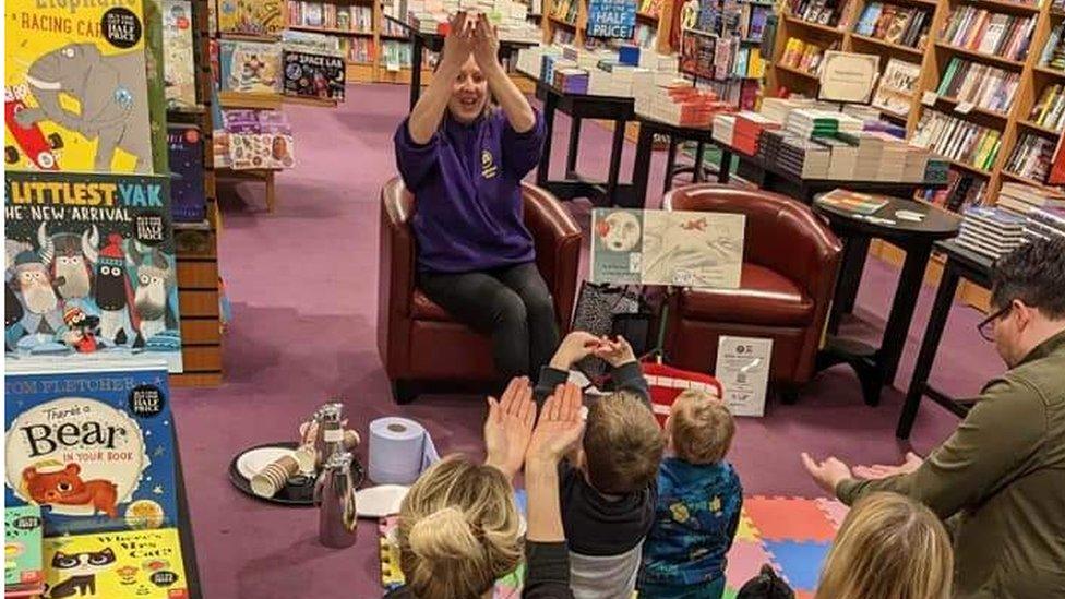 Ms Holt doing a Makaton book-reading for a group of children