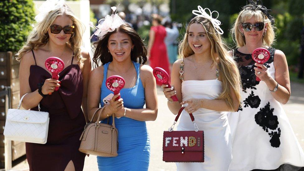 A group of women with electric fans