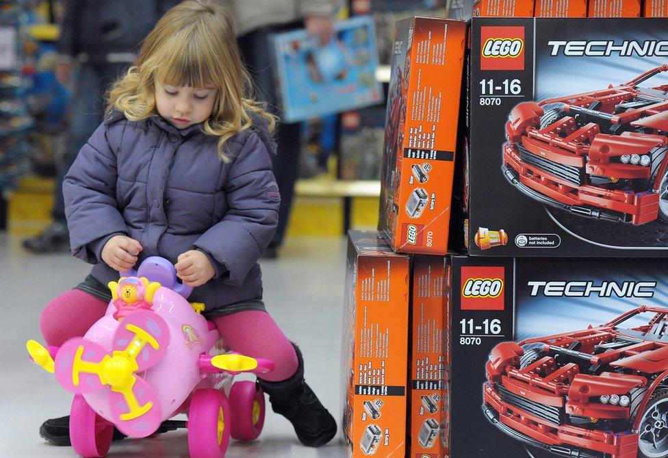 File pic of girl playing with toy in a store in France