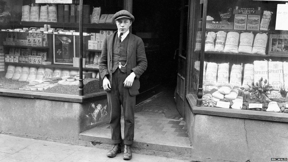 Black and white photo of Harold Jones outside his shop