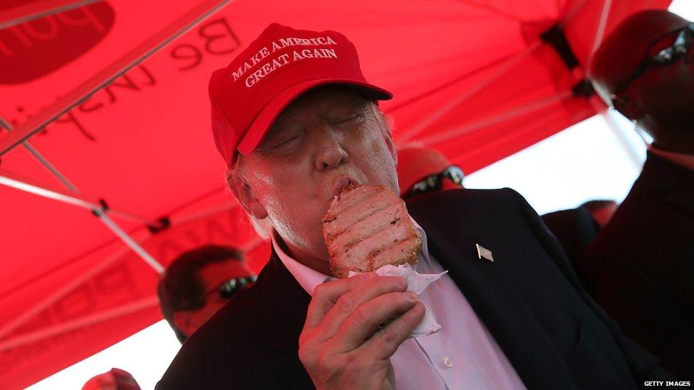 Republican presidential candidate Donald Trump eats a pork chop on a stick