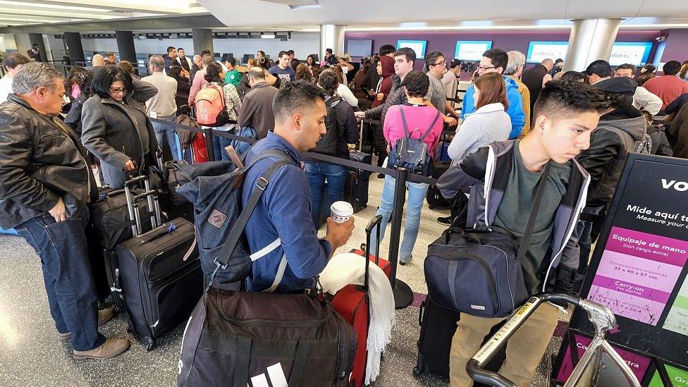 Holiday travelers wait in line to check in at the Los Angeles International Airport, California on December 22, 2016.