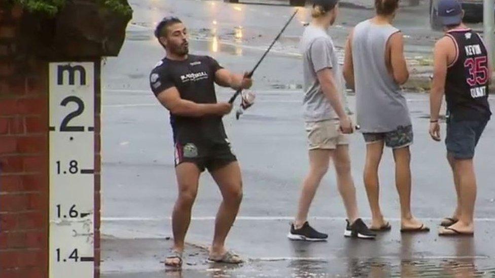 Mr Jordanou fishes in the floods