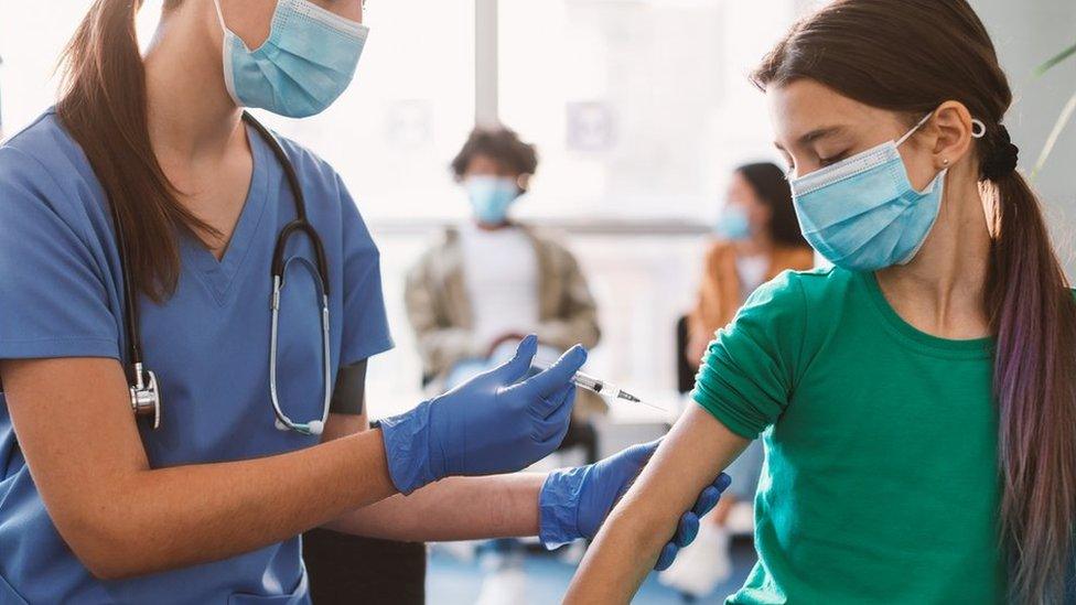 Schoolgirl getting vaccinated