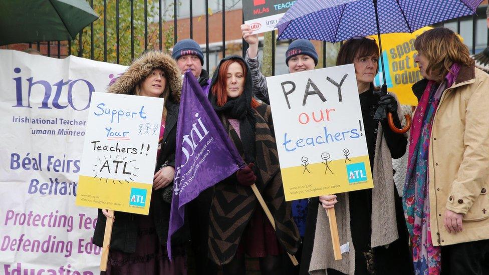 Into and ATL union members strike outside a school