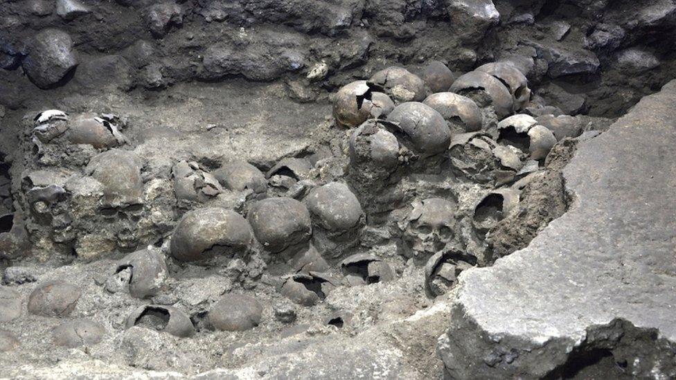 A photo shows parts of an Aztec tower of human skulls, believed to form part of the Huey Tzompantli