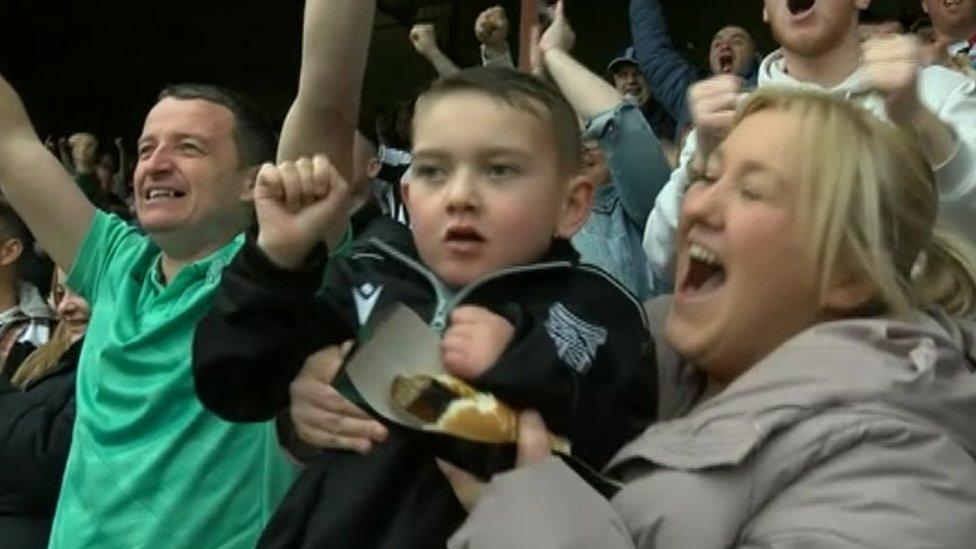 Reggie cheering with his parents Lee and Michelle Aslin