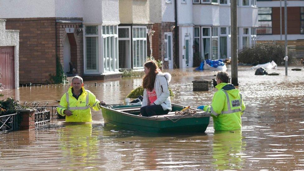 Rescue workers help a resident to safety on a boat following Storm Dennis on February 17, 2020 in Hereford