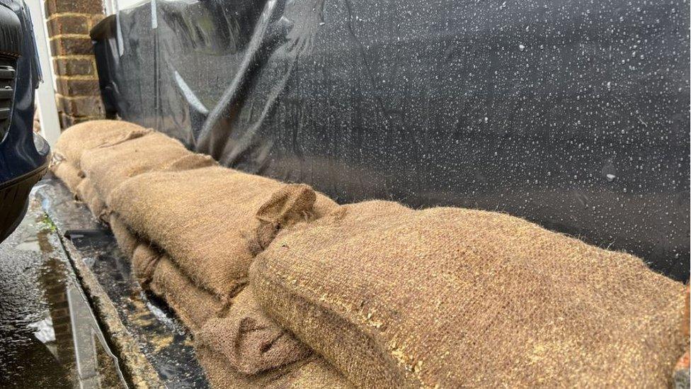 Sandbags next to a garage