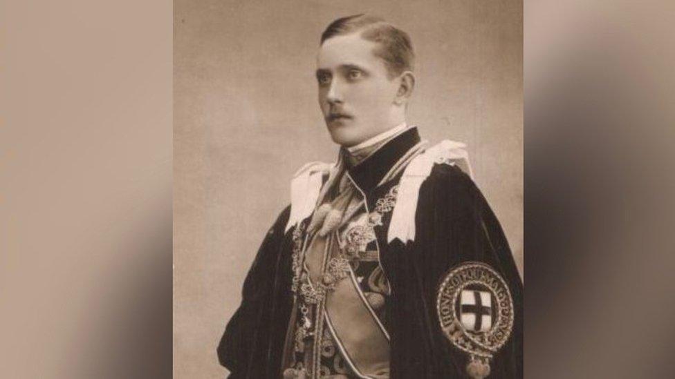 Man with short hair and moustache wearing royal robes in black and white photo