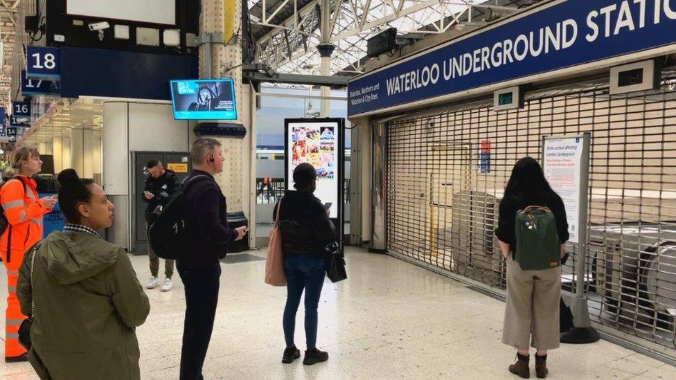 People standing outside a close Waterloo station Tube entrance