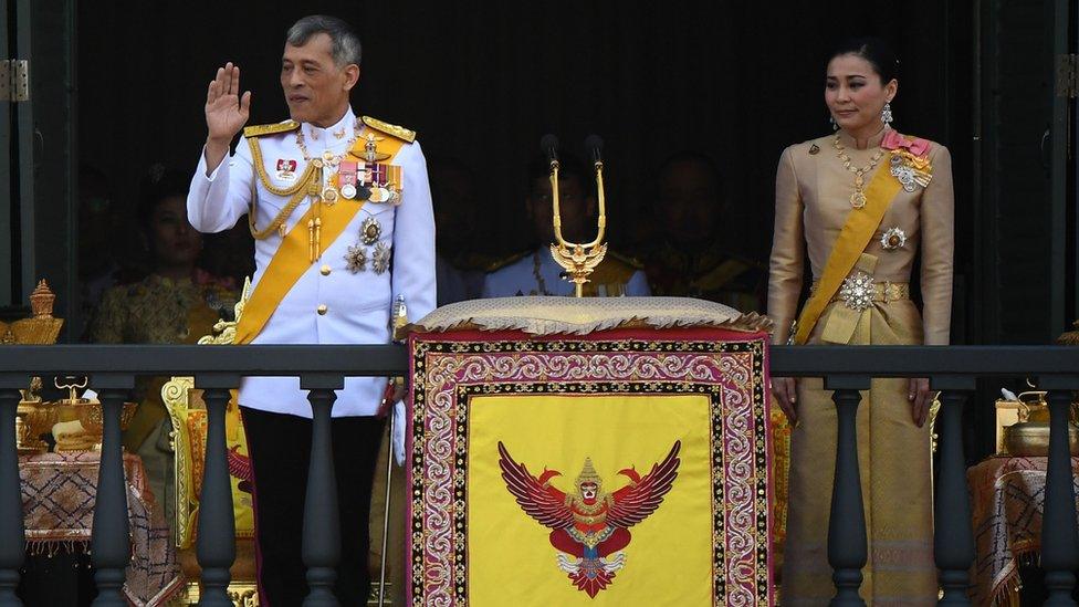 King Maha Vajiralongkorn and Queen Suthida wave to well-wishers