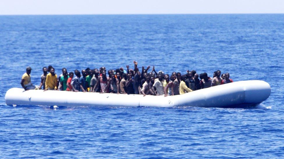 Migrants on a dinghy off the Libyan coast