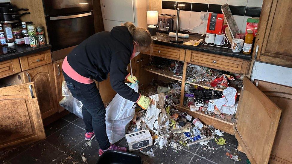 A woman clearing out a kitchen