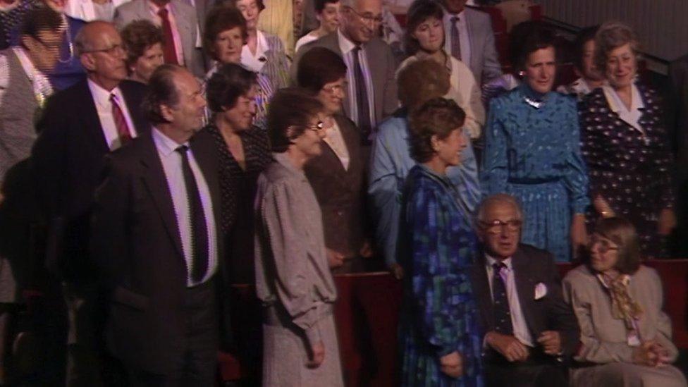 Renate Collins standing behind (to the right of) Sir Nicholas Winton and his wife Grete (seated) in the That's Life audience in 1988