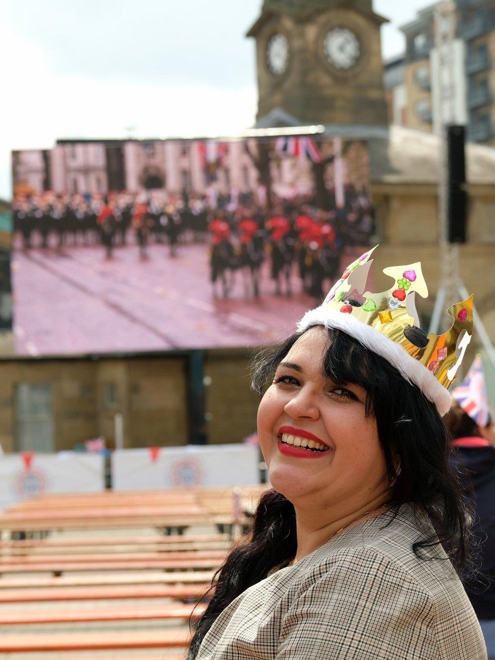 A woman wearing a paper crown at Newcastle's Times Square