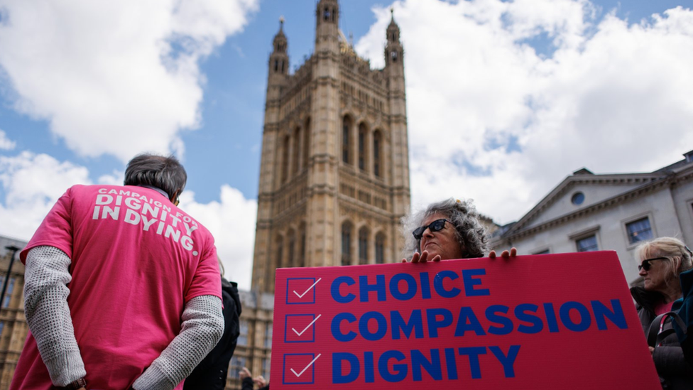 Pro-assisted dying campaigners gather outside the UK Houses of Parliament as MPs prepare to debate over changing the law on assisted dying