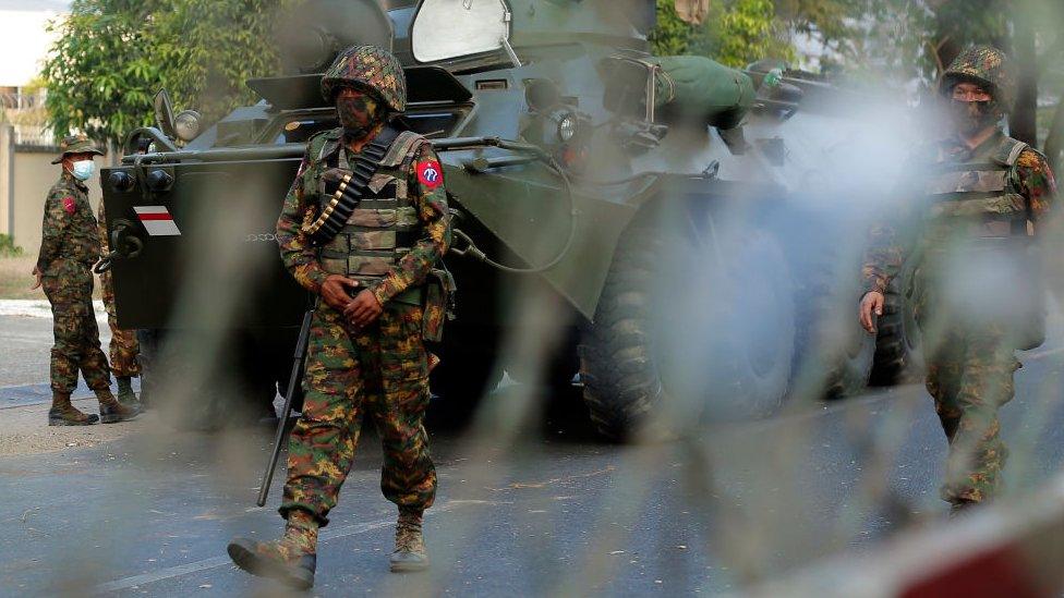 Myanmar soldiers patrol the street during a demonstration against the military coup outside the Central Bank in Yangon, Myanmar