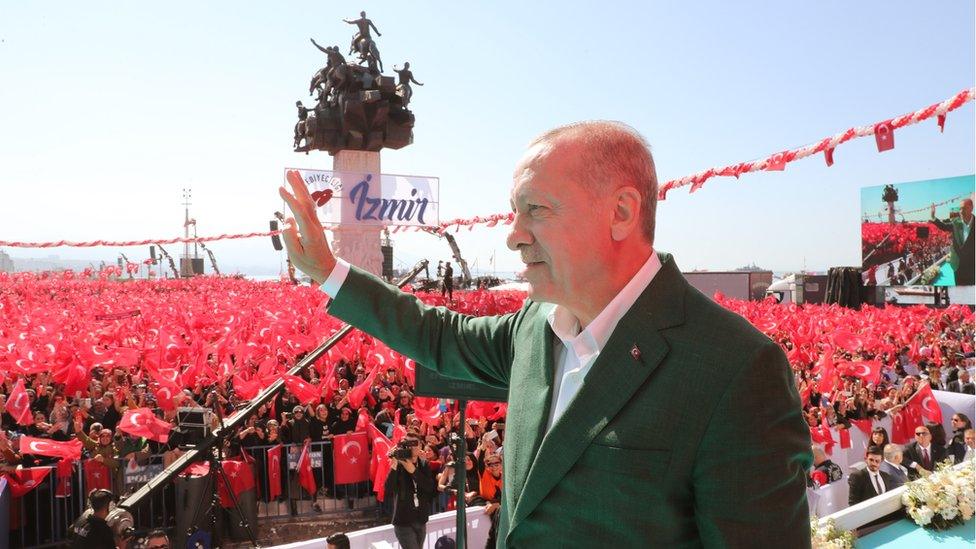 A handout photo made available by the Turkish President Press office shows Turkish President Recep Tayyip Erdogan as he greets supporters during his Justice and Development Party (AK Party) and Nationalist Movement Party (MHP) local election campaign rally in Izmir, Turkey, 17 March 2019