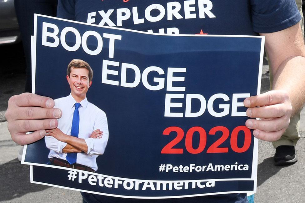 A fan with a flyer saying 'Boot Edge Edge'